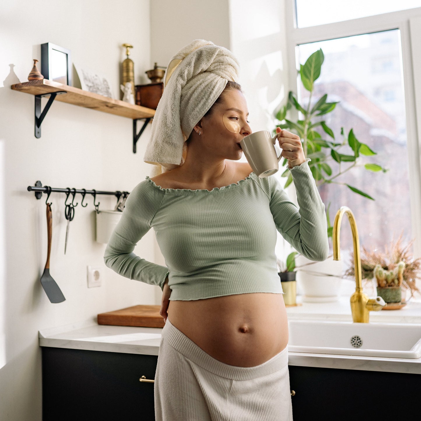 Happy pregnant mother enjoying a cup of HOT COFFIG