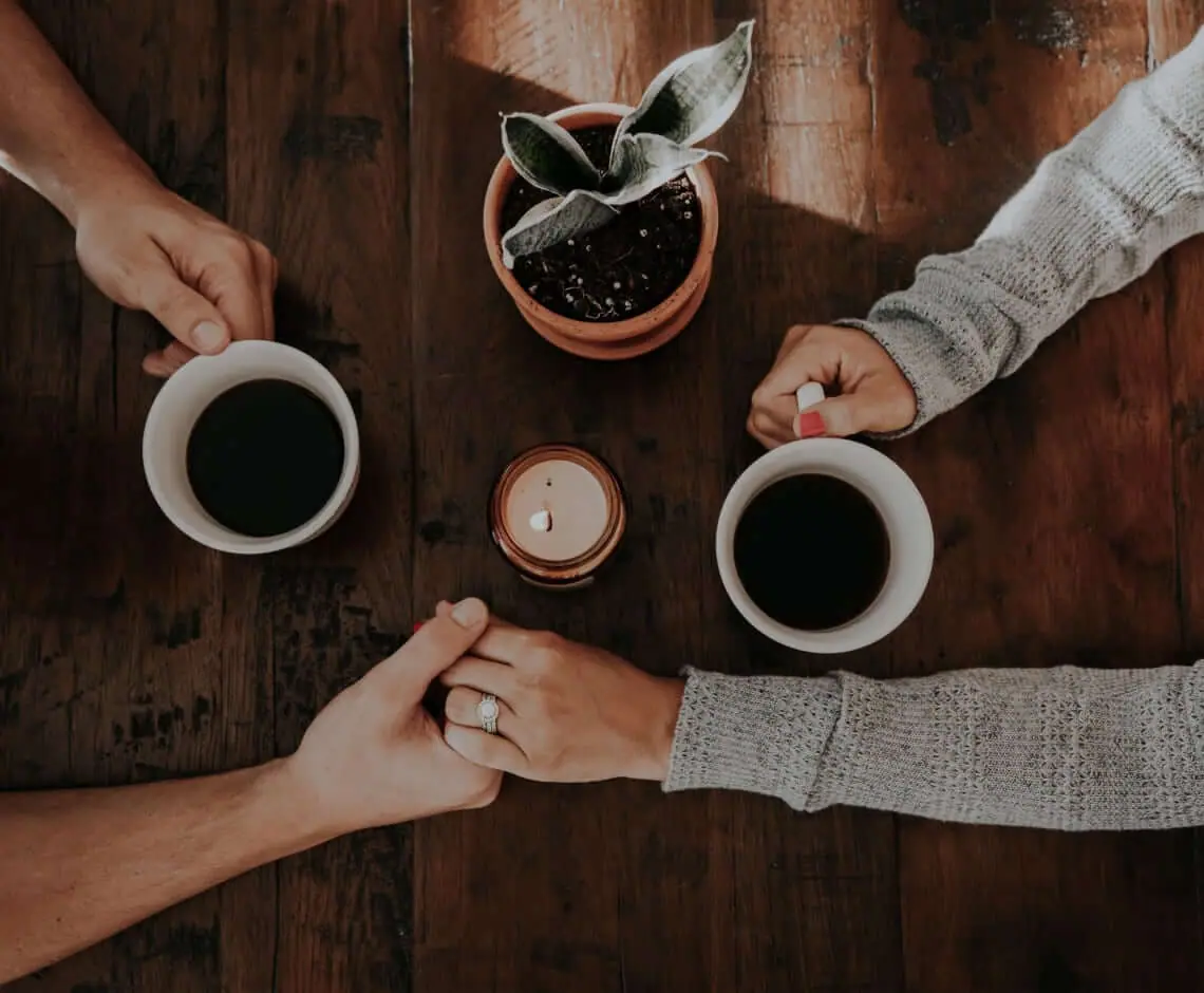 Two cups of Coffig shared across a table