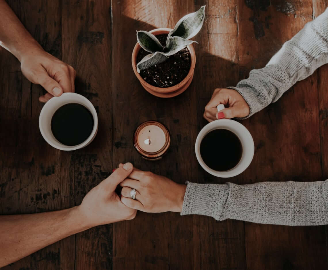 Two cups of Coffig shared across a table